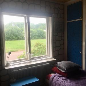 1 dormitorio con ventana con 1 cama y 1 cama sidx sidx sidx sidx en Arthome Småland, en Ruda