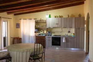 a kitchen with a table and a table and a kitchen with a tableablish at Villa Lo Verde in Partinico