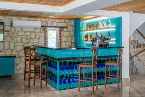 a blue bar in a room with chairs at DAM HOTEL LARA in Antalya