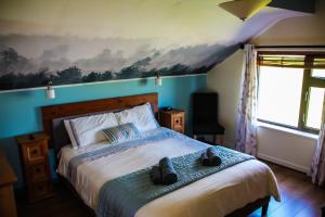 a bedroom with a bed with two shoes on it at Slieve Elva B&B in Lisdoonvarna