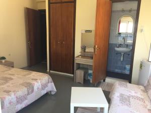 A bed or beds in a room at Platanos Rooms