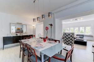 a dining room and living room with a table and chairs at Villa Dalmare in Novi Vinodolski