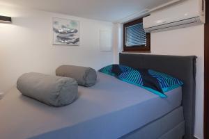 a bed with two pillows on it in a room at Villa Mariella in Novalja +116 photos