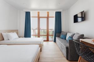 a hotel room with two beds and a couch at Lucky Residence in Zatoka +34 photos