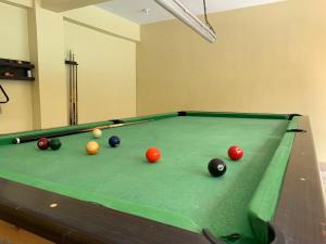 a pool table with balls on it in a room at Felicitas Tagaytay in Tagaytay