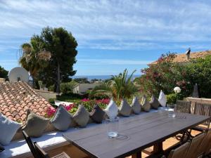 a wooden table with wine glasses on a patio at Villa Santa Lavinia in Palma de Mallorca