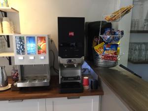 a kitchen counter with a coffee maker and a mixer at Marsfjäll Mountain Lodge Vandrarhem i Saxnäs in Saxnäs