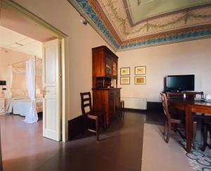 a living room with a dining room table and a ceiling at Palazzo Gambuzza in Ispica