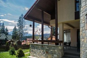 a porch of a house with a view of the mountains at Transylvanian Villa in Predeal