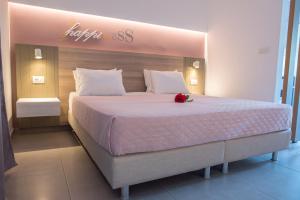 a bedroom with a large bed with a flower on it at Gelli Apartments in Kos Town