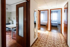 a hallway with a room with a bed and a mirror at Appartamento Calmo 3SX in Venice-Lido