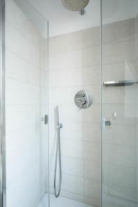 a shower stall with a glass shower door at Appartamento Calmo 3SX in Venice-Lido