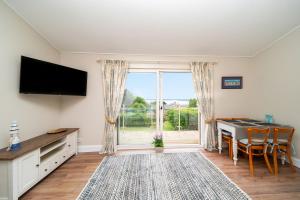 a living room with a table and a large window at FerryView in Broughty Ferry