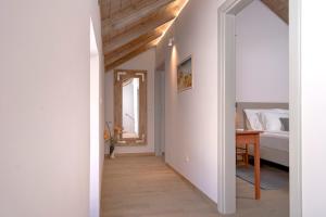 a hallway leading to a bedroom with a bed and a table at Villa Zanino in Veliko Grablje