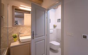 a bathroom with a toilet and a sink at Villa Zanino in Veliko Grablje