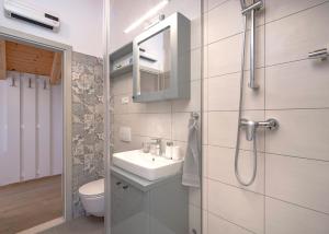 a bathroom with a sink and a toilet and a mirror at Villa Zanino in Veliko Grablje