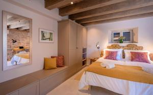 a bedroom with a large bed and a mirror at Villa Zanino in Veliko Grablje