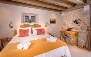 a bedroom with a large bed with towels on it at Villa Zanino in Veliko Grablje +35 photos