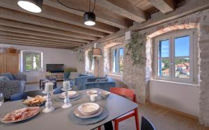 a kitchen and living room with a table and chairs at Villa Zanino in Veliko Grablje