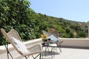 a balcony with two chairs and a table with a view at Villa Zanino in Veliko Grablje