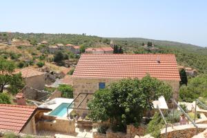 a house with a swimming pool in a village at Villa Zanino in Veliko Grablje