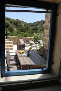 a view of a table and chairs from a window at Villa Zanino in Veliko Grablje