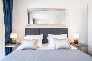 a bedroom with a large bed with a mirror above it at Corallium Blue in Pomena +24 photos