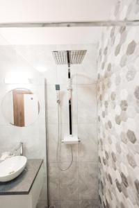 a bathroom with a sink and a shower at Vila GRANDE MAMAIA NORD in Mamaia Sat/Năvodari +62 photos