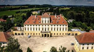 a large white building with a red roof at Innviertler Versailles in Aurolzmünster