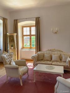 a living room with a couch and a table at Innviertler Versailles 