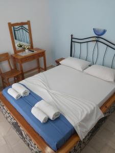 a bedroom with a bed with two towels on it at Stavros Beach Villas in Perivolos
