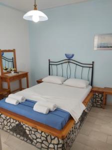 a bedroom with a bed with towels on it at Stavros Beach Villas in Perivolos