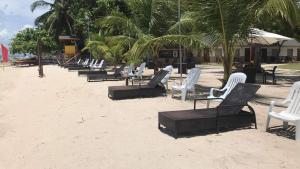a row of lawn chairs on the beach at Anaya Beach Resort in Bantayan Island