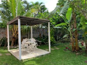 a table and chairs in a pavilion in a garden at Felicitas Tagaytay in Tagaytay