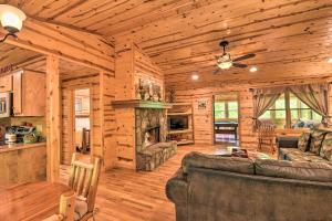 a living room with a fireplace in a log cabin at The Apple Dumpling Cabin Pool Table, Grill in Clarkesville