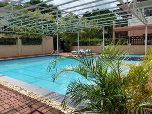 a large swimming pool with a glass canopy over it at Felicitas Tagaytay in Tagaytay