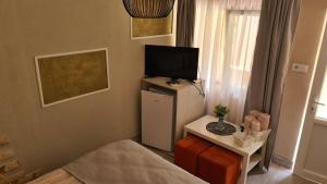 a small room with a television on top of a refrigerator at Casa Lira Orșova in Orşova