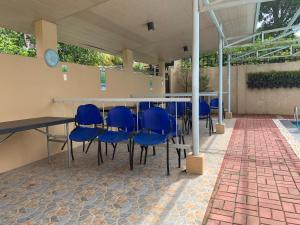 a table with blue chairs in a patio at Felicitas Tagaytay in Tagaytay