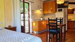 a kitchen with a table and chairs in a room at Tropical Studio in Órgiva +46 photos