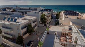 an overhead view of a street with buildings and the ocean at Diogenis Seaside Suite in Rethymno Town