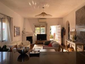 a living room with a couch and a tv at LA HIGUERA in Torrox