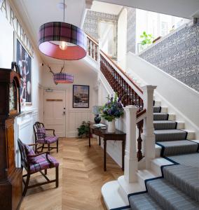 a staircase in a home with a stair case at Art House Apartments in Inverness