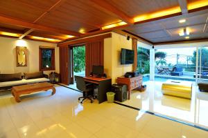 a living room with a desk and a couch at Villa Melitta, Pool, Beach, 360-SeaViews, 6-bed Thai Luxury on Best Location in Samui in Bang Rak Beach