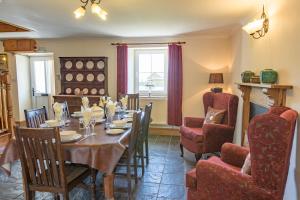 a dining room with a table and chairs at Hawton in Kidwelly