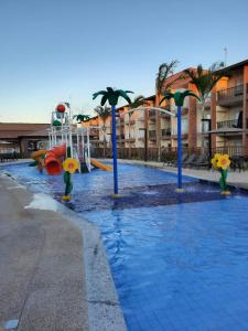 a pool in a resort with a water park at Resort Ondas Praia in Porto Seguro