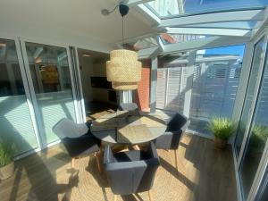 a dining room with a table and chairs on a balcony at Hafenliebe Wiek in Wiek auf Rügen 