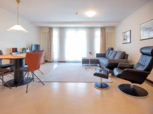 a living room with a couch and chairs and a table at Strandvillen Binz - 1-Raum-Ferienwohnung mit Meerblick und Balkon SV-763 in Binz