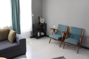a living room with two chairs and a couch at Alpat Homes in Kemer