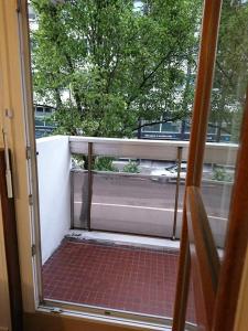 an open door to a balcony with a view of a street at LPA in Annecy