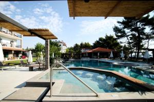 a swimming pool at a resort with a swimming pool at Nostos Hotel in Afitos